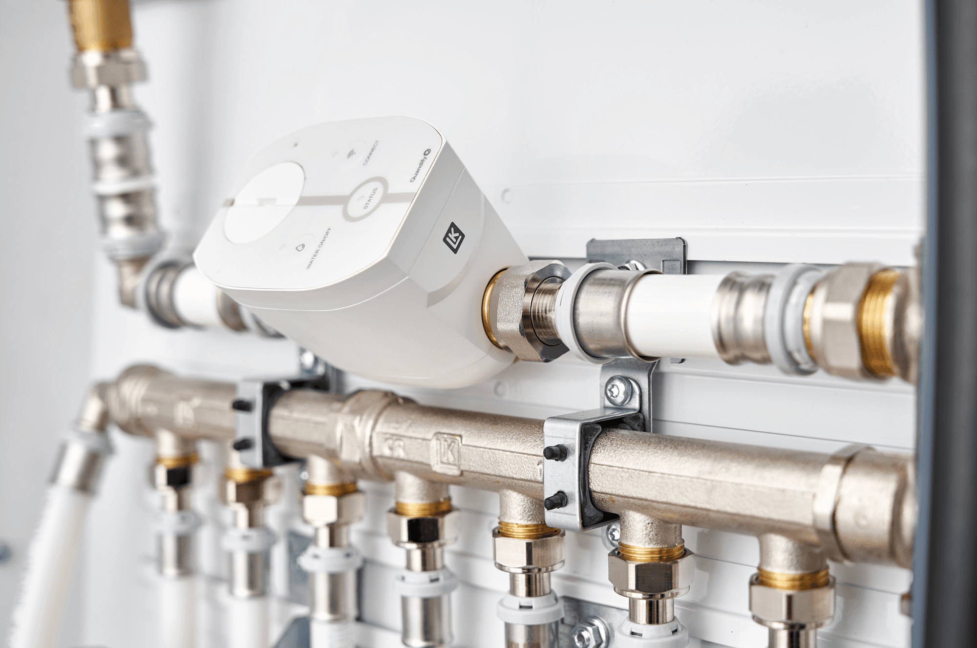 Modern brass shower fixtures on white wall